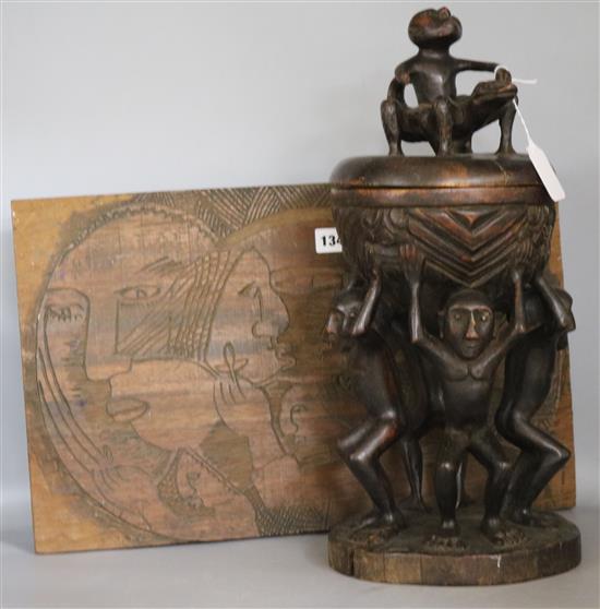 A tribal carved lidded vessel and a carved panel